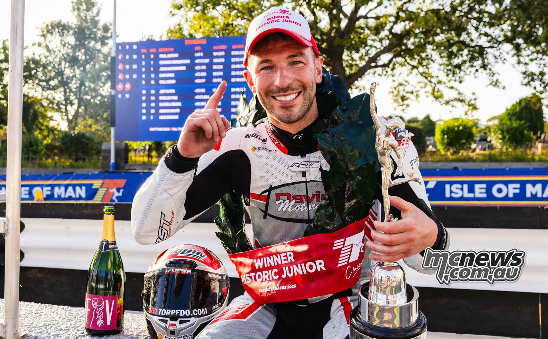Paul Jordan smiles with his trophy beside the Historic Junior winner’s board