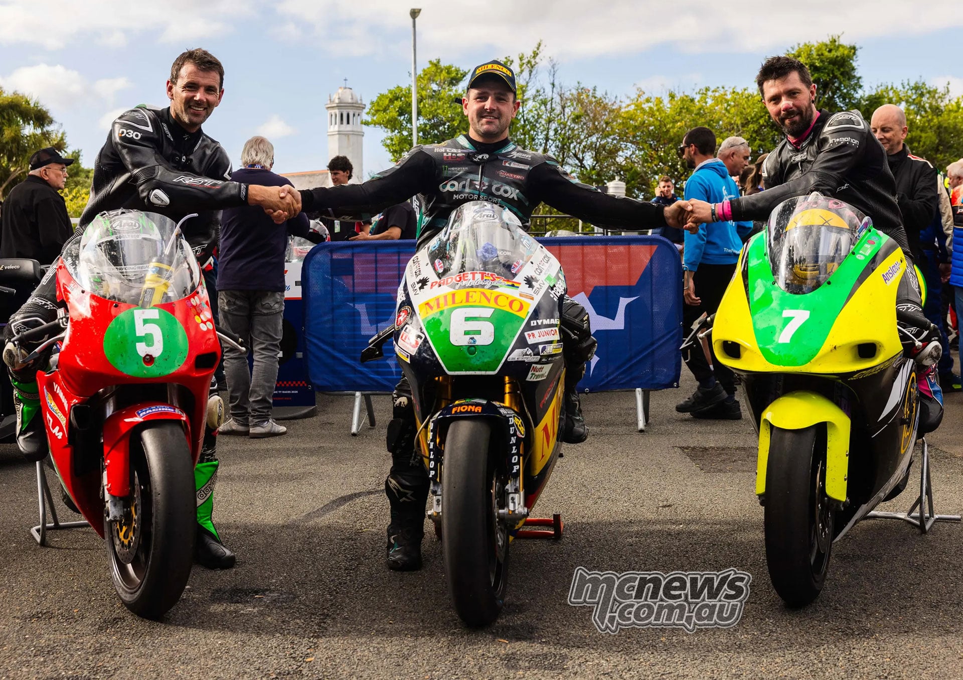 The three Lightweight podium finishers pose on their motorcycles in parc ferme