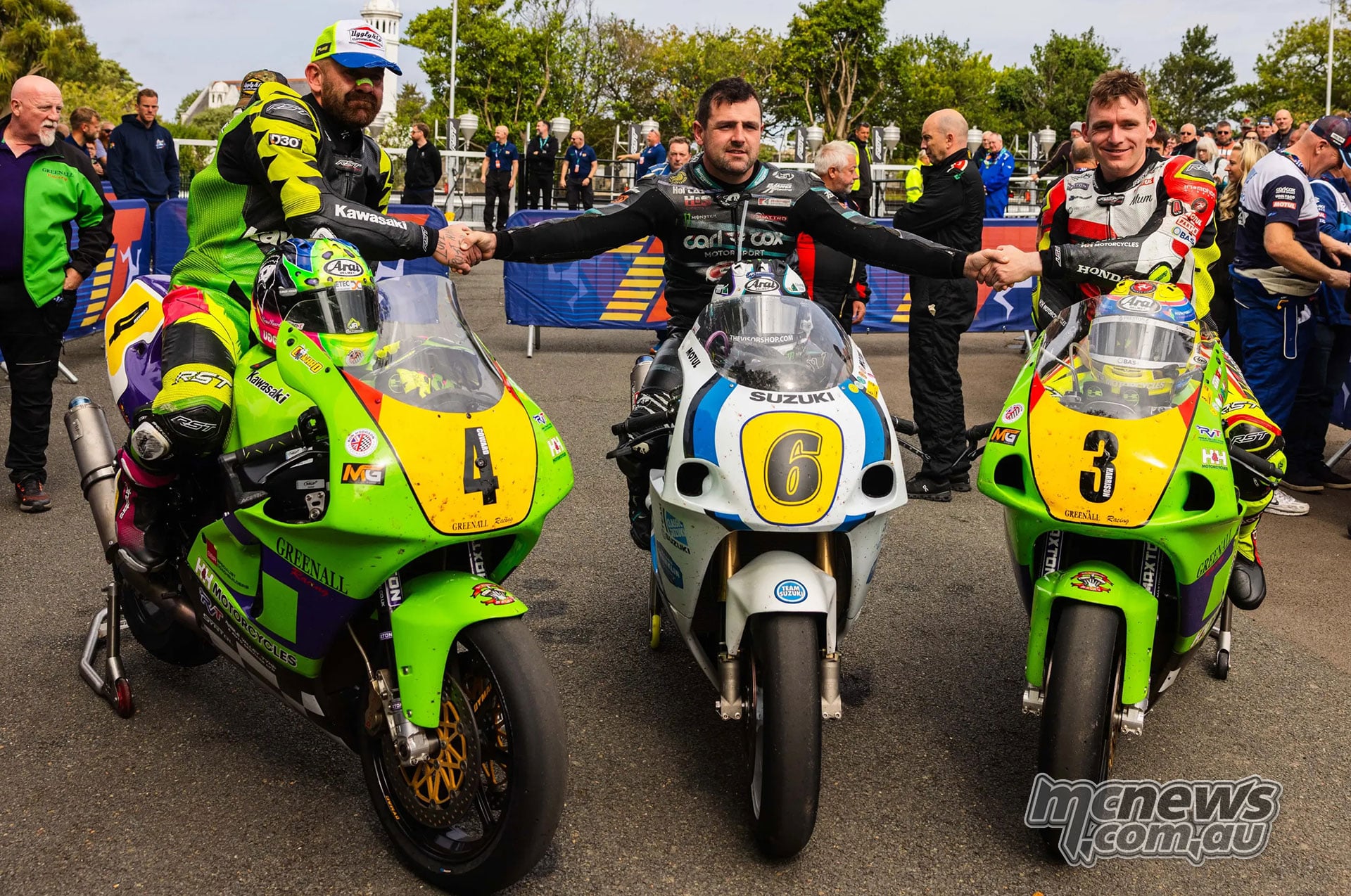 Jamie Coward, Michael Dunlop and Nathan Harrison pose with their motorcycles in parc ferme