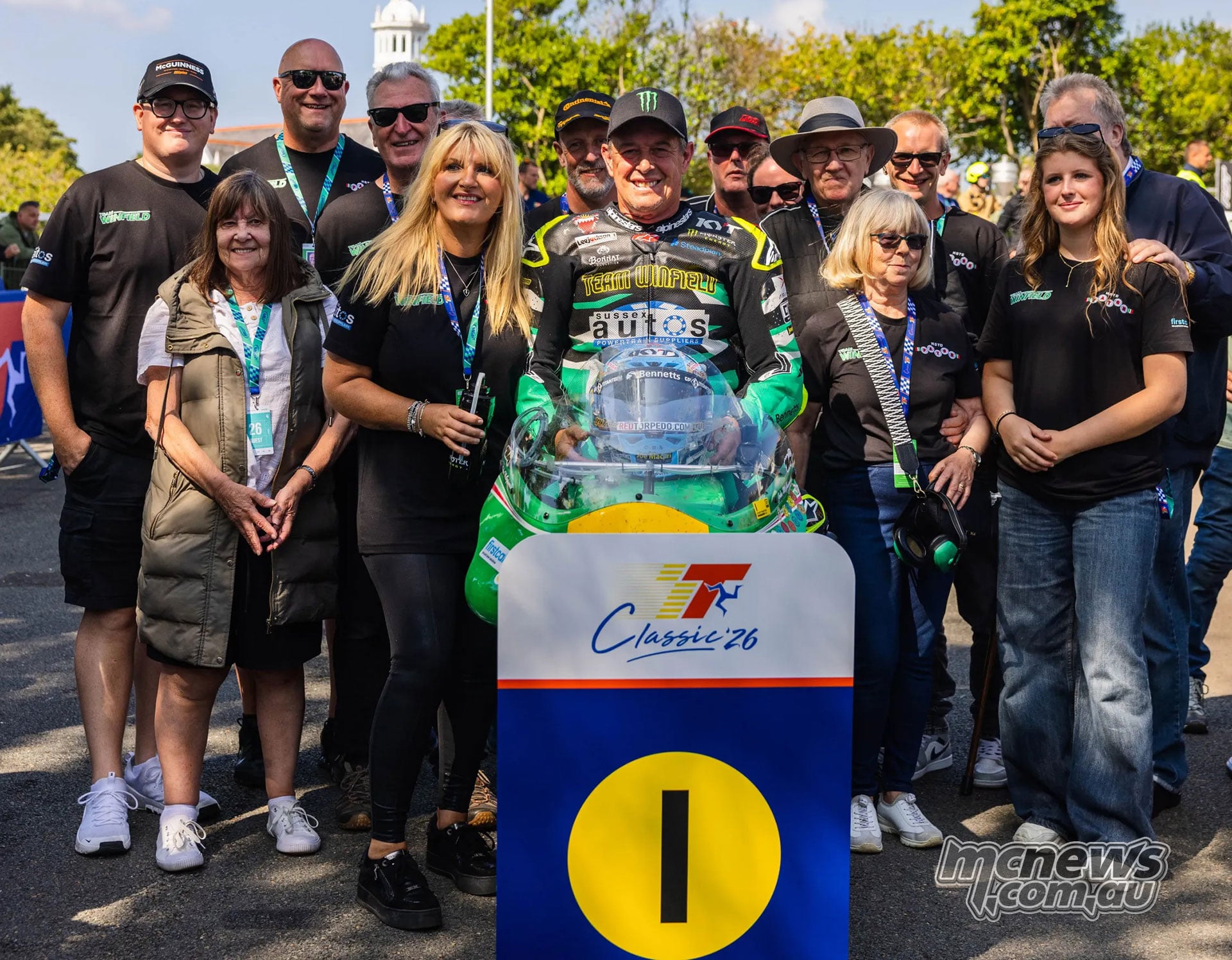 John McGuinness poses with his Paton, team and family in parc ferme
