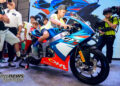 Young rider sitting on the Ohvale GP-5 250 during its unveiling as other children watch.