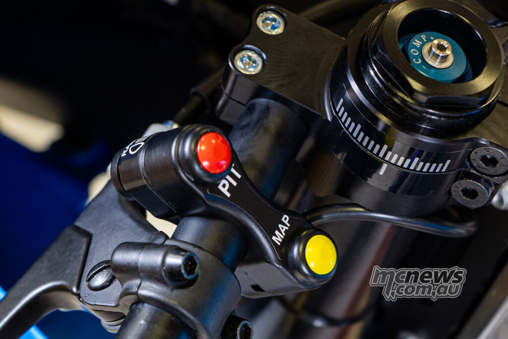 Close-up of the map and pit-limiter buttons beside the adjustable OHRACING fork top on the Ohvale GP-5.