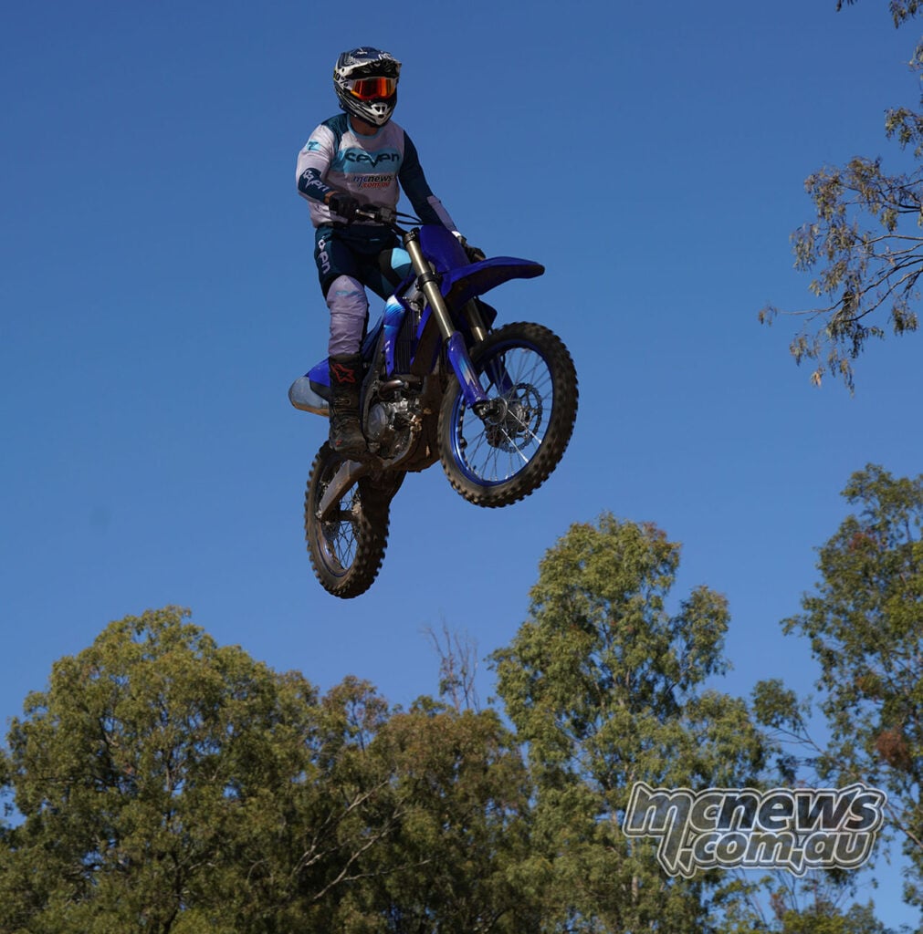 MCNews tester airborne on the 2027 Yamaha YZ250F against a blue sky