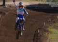 MCNews tester raising a fist while riding the 2027 Yamaha YZ250F