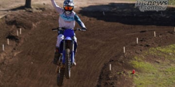 MCNews tester raising a fist while riding the 2027 Yamaha YZ250F