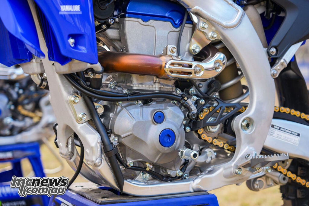 Close-up of the redesigned 2027 Yamaha YZ250F engine, frame and exhaust header