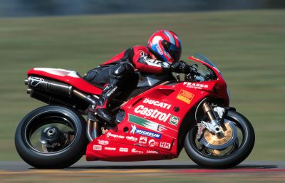 Steve Martin leans his red Ducati Dealer Team 996RS into a corner during the 1999 Australian Superbike season.