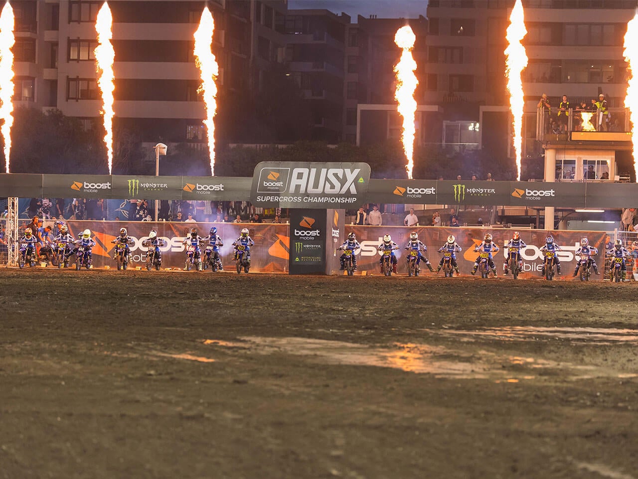 Yamaha YZ65 Cup riders lined up under fireworks at the 2025 Melbourne Supercross event