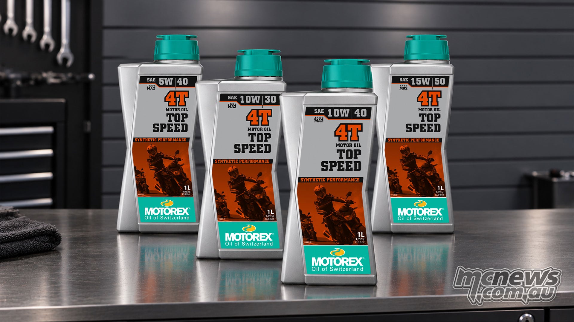 Four one-litre MOTOREX Top Speed 4T bottles in 5W/40, 10W/30, 10W/40 and 15W/50 grades on a workshop bench.