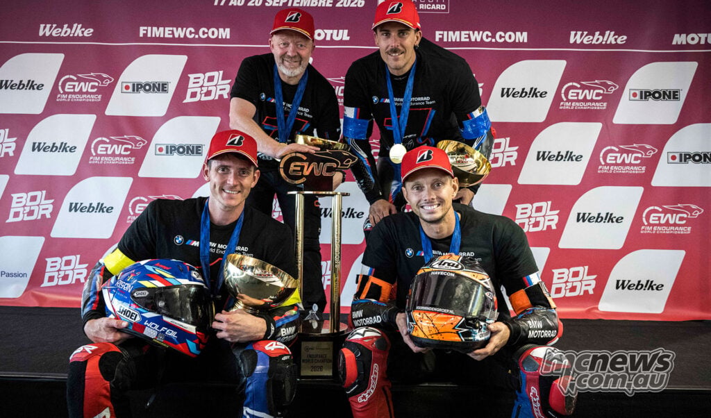 BMW endurance riders and team management pose with helmets, medals and the 2026 EWC championship trophy at Paul Ricard.