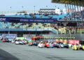 Payne and Rousseau’s yellow number 45 sidecar leads the field along the start-finish straight at TT Circuit Assen.