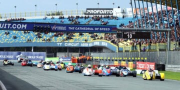 Payne and Rousseau’s yellow number 45 sidecar leads the field along the start-finish straight at TT Circuit Assen.