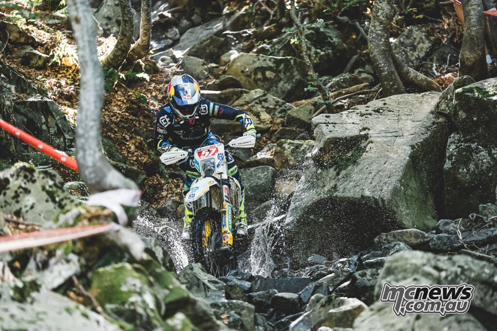 Billy Bolt riding his Husqvarna through a rocky water section at the Abestone Hard Enduro.