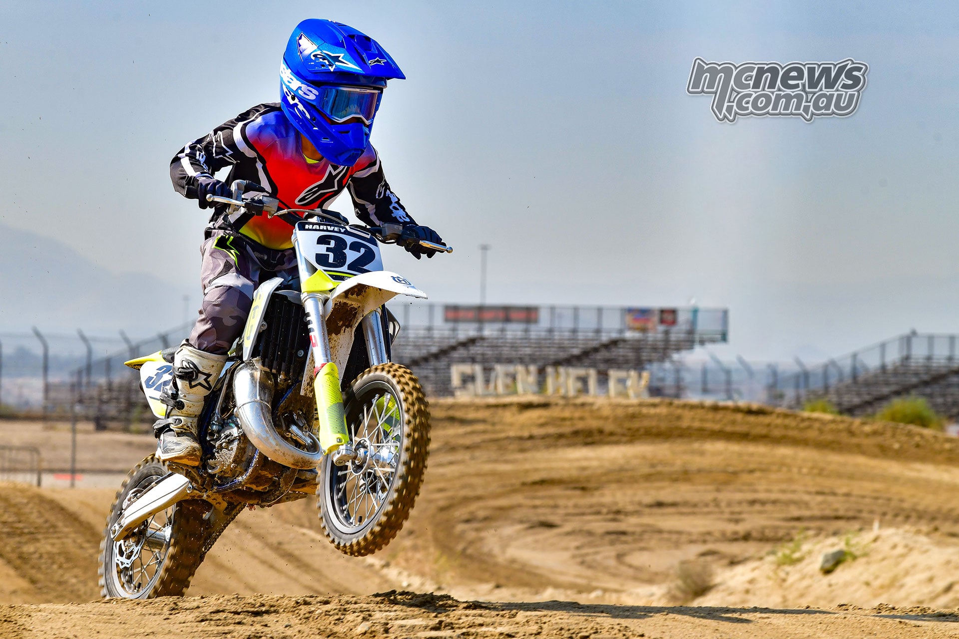 Harvey lifts the front wheel of the 2026 Husqvarna TC 65 over a rise on a motocross track.