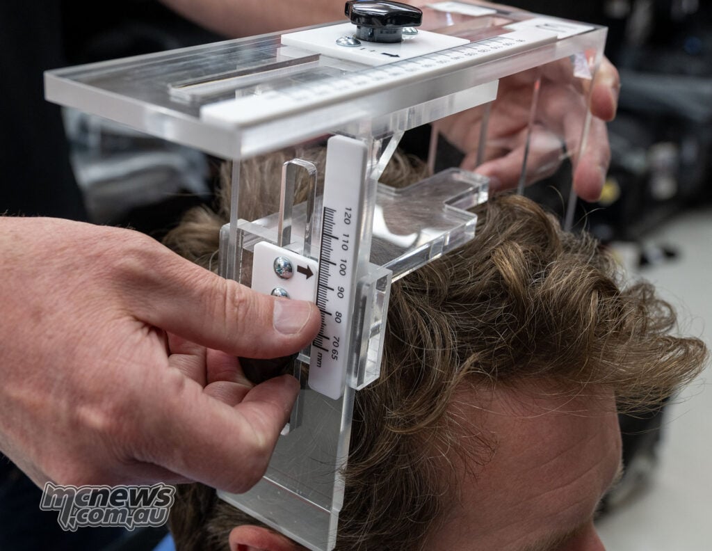 Ant having his head height measured with the clear acrylic Shoei PFS jig.