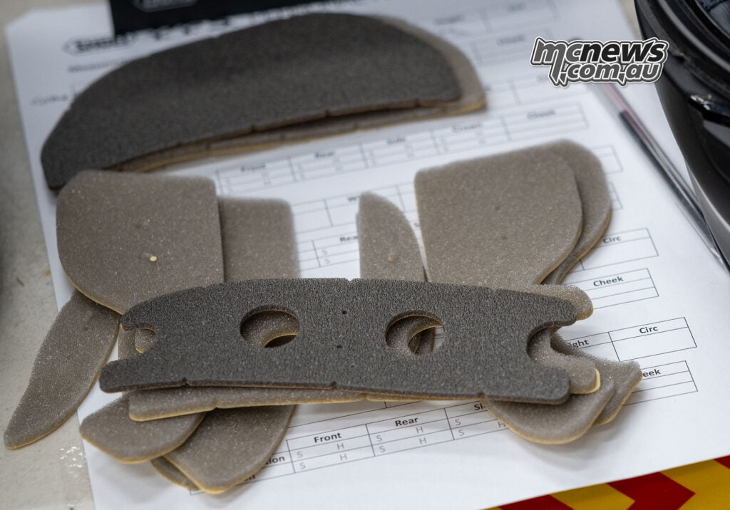 Soft and firm Shoei PFS adjustment pads arranged over Trev’s fitting worksheet.