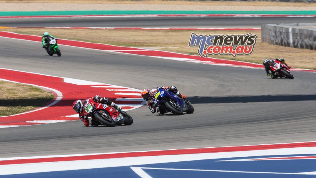 Darryn Binder on the red number 53 Ducati leads Harrison Voight’s blue number 129 Yamaha through a COTA corner.