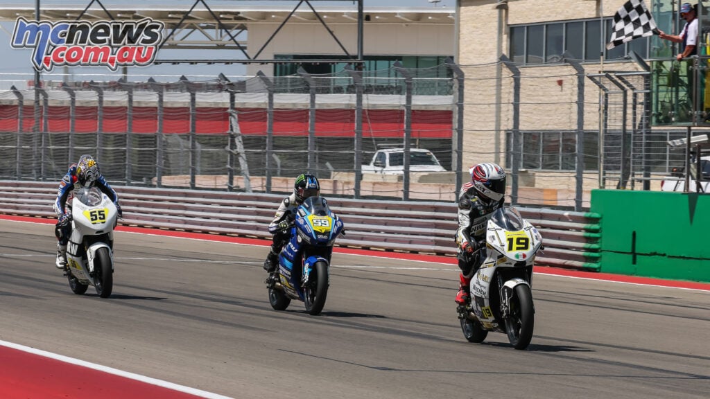 Nathan Gouker’s number 19 crosses the finish line ahead of Sam Drane’s number 59 and Jake Paige’s number 55 under the chequered flag.