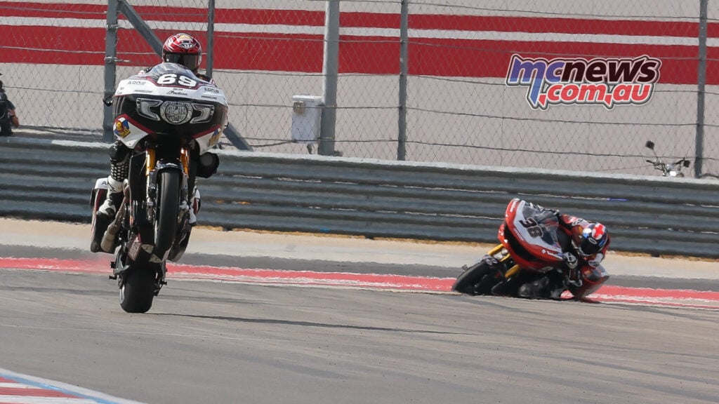 Hayden Gillim’s number 69 Indian lifts its front wheel with Bradley Smith’s number 38 Harley-Davidson behind.
