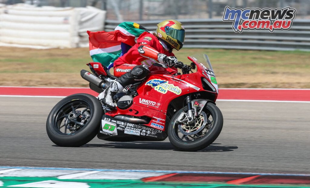 Darryn Binder rides the number 53 Ducati with a gold helmet and South African flag at COTA.