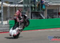 Hayden Gillim lifts the front wheel of his Indian bagger as he crosses the finish line at COTA.