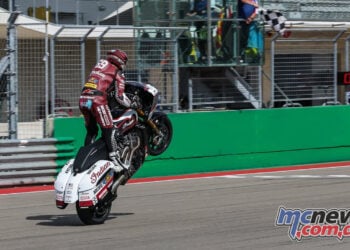 Hayden Gillim lifts the front wheel of his Indian bagger as he crosses the finish line at COTA.