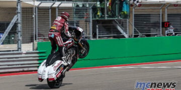 Hayden Gillim lifts the front wheel of his Indian bagger as he crosses the finish line at COTA.