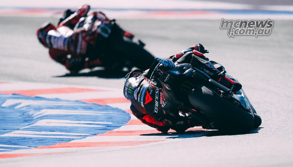 Rear view of Marco Bezzecchi's Aprilia following Marc Marquez's Ducati through a Misano corner.