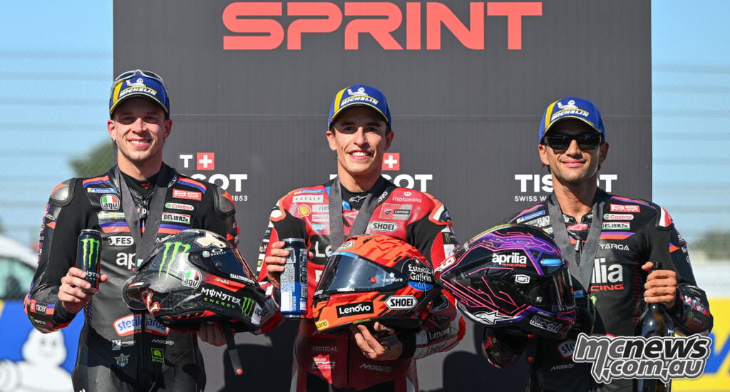Marco Bezzecchi, Marc Marquez and Jorge Martin pose with their helmets after the Misano Sprint.