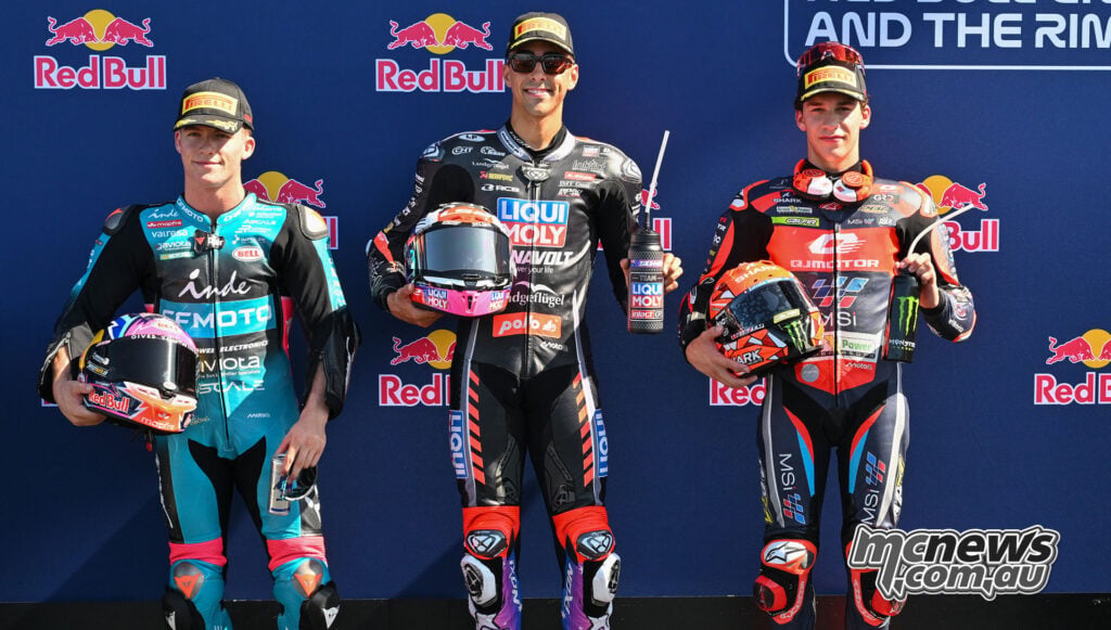Daniel Holgado, Senna Agius and Angel Piqueras pose with their helmets after Moto2 qualifying at Misano.