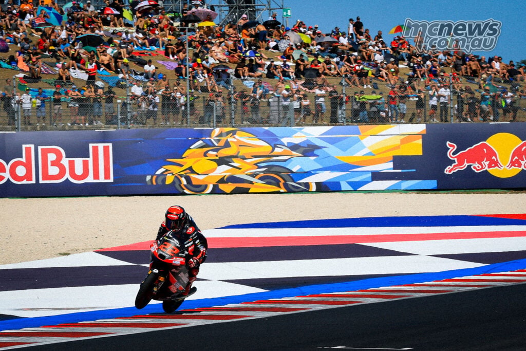 David Almansa rides through Misano with colourful run-off and a crowded grandstand behind him.