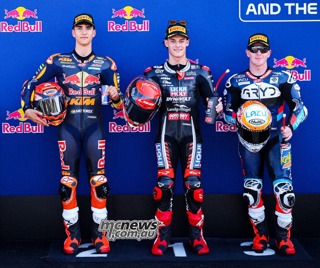 Brian Uriarte, David Almansa and Joel Kelso stand with their helmets after securing Moto3 front-row positions.