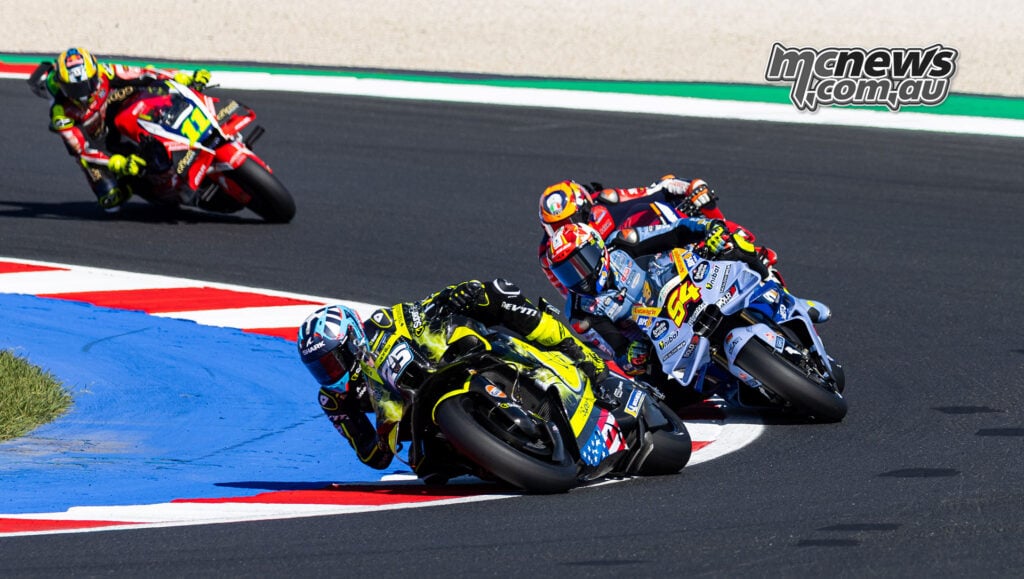 Raul Fernandez's yellow-and-black Aprilia leads Fermin Aldeguer, Luca Marini and Diogo Moreira through a corner.