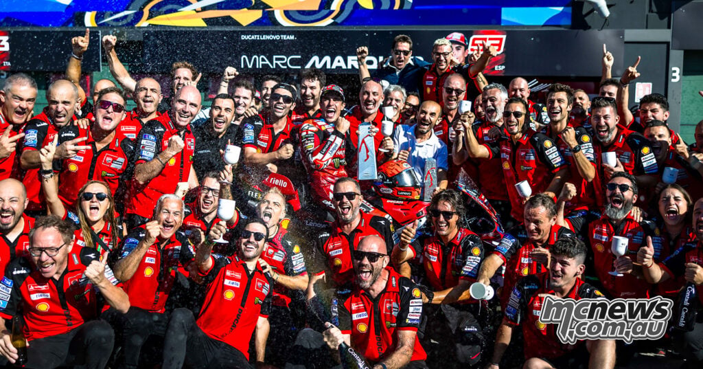 Ducati Lenovo team members gather outside the garage for a group celebration after the Misano victory.