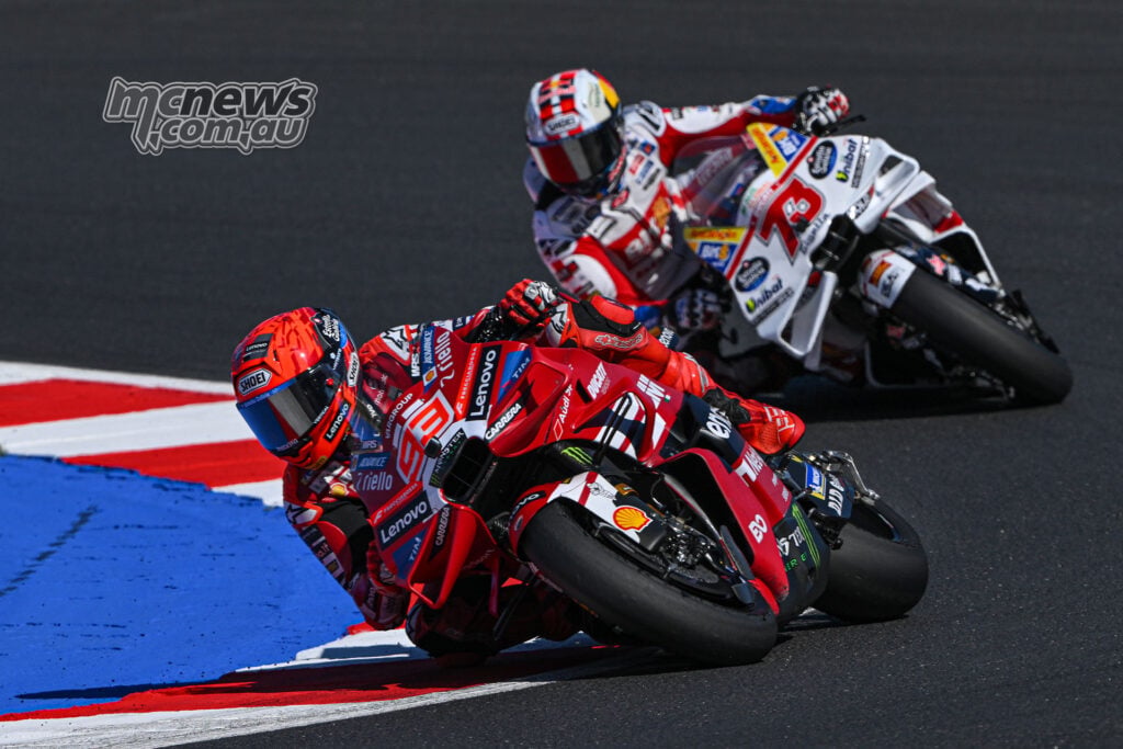 Marc Marquez corners on his red Ducati with Alex Marquez following closely on the white Gresini Ducati.