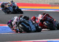 Jorge Martin leads Marc Marquez through a corner at Misano, with Alex Marquez following behind.