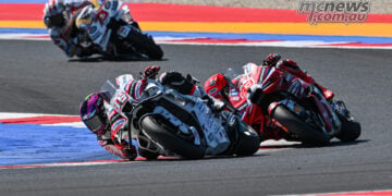 Jorge Martin leads Marc Marquez through a corner at Misano, with Alex Marquez following behind.