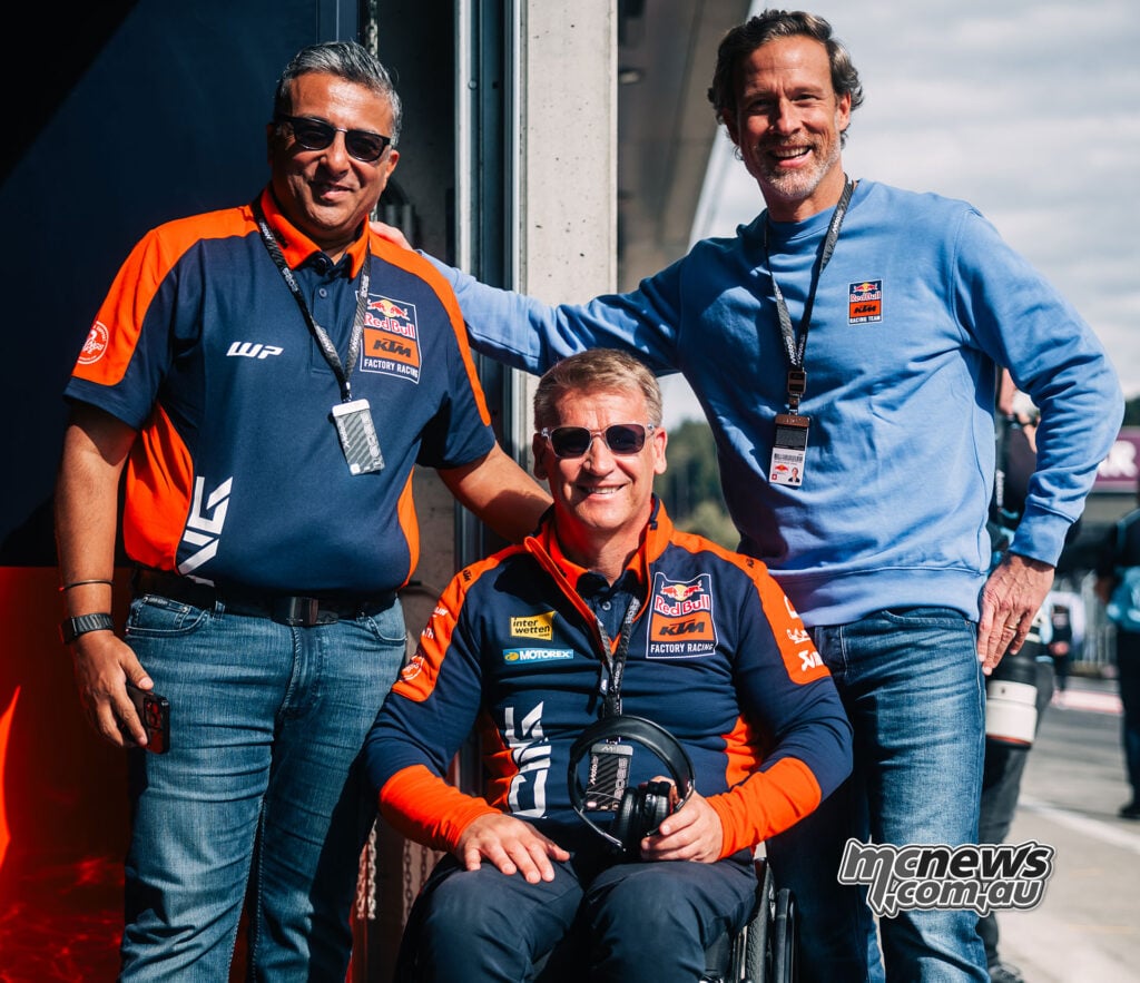 Dinesh Thapar standing on the left, Pit Beirer seated in the centre and Gottfried Neumeister standing on the right at the Red Bull Ring.