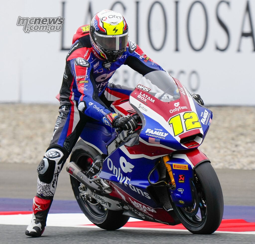 Filip Salac with his left leg extended while riding the number 12 American Racing Moto2 bike at the Red Bull Ring.