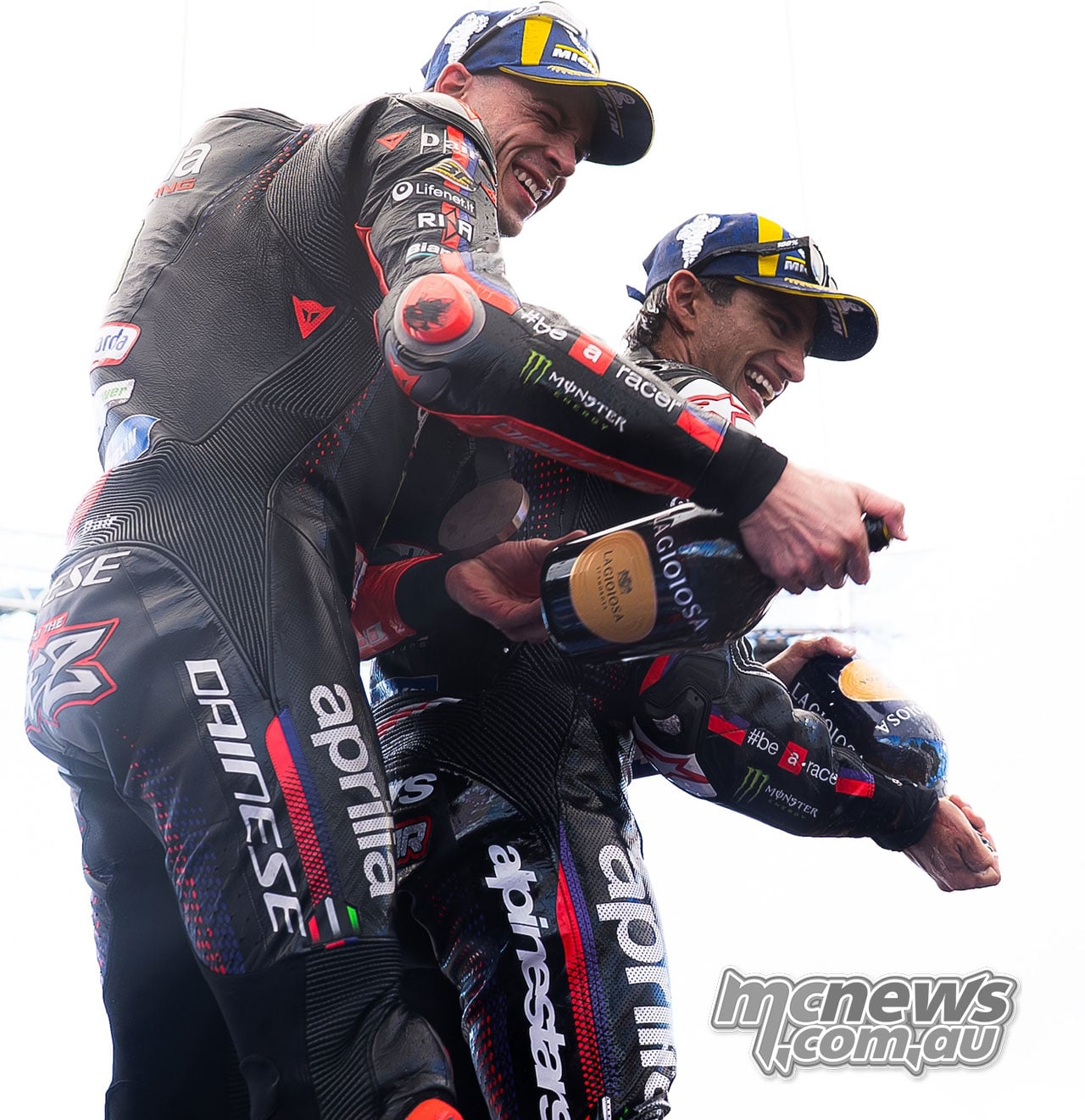 Marco Bezzecchi and Jorge Martin spray champagne during the Austrian Sprint celebrations.