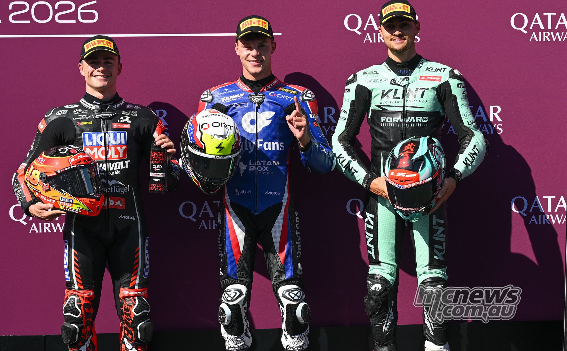 Manuel Gonzalez, Filip Salac and Alex Escrig pose with their helmets after Moto2 qualifying in Austria.