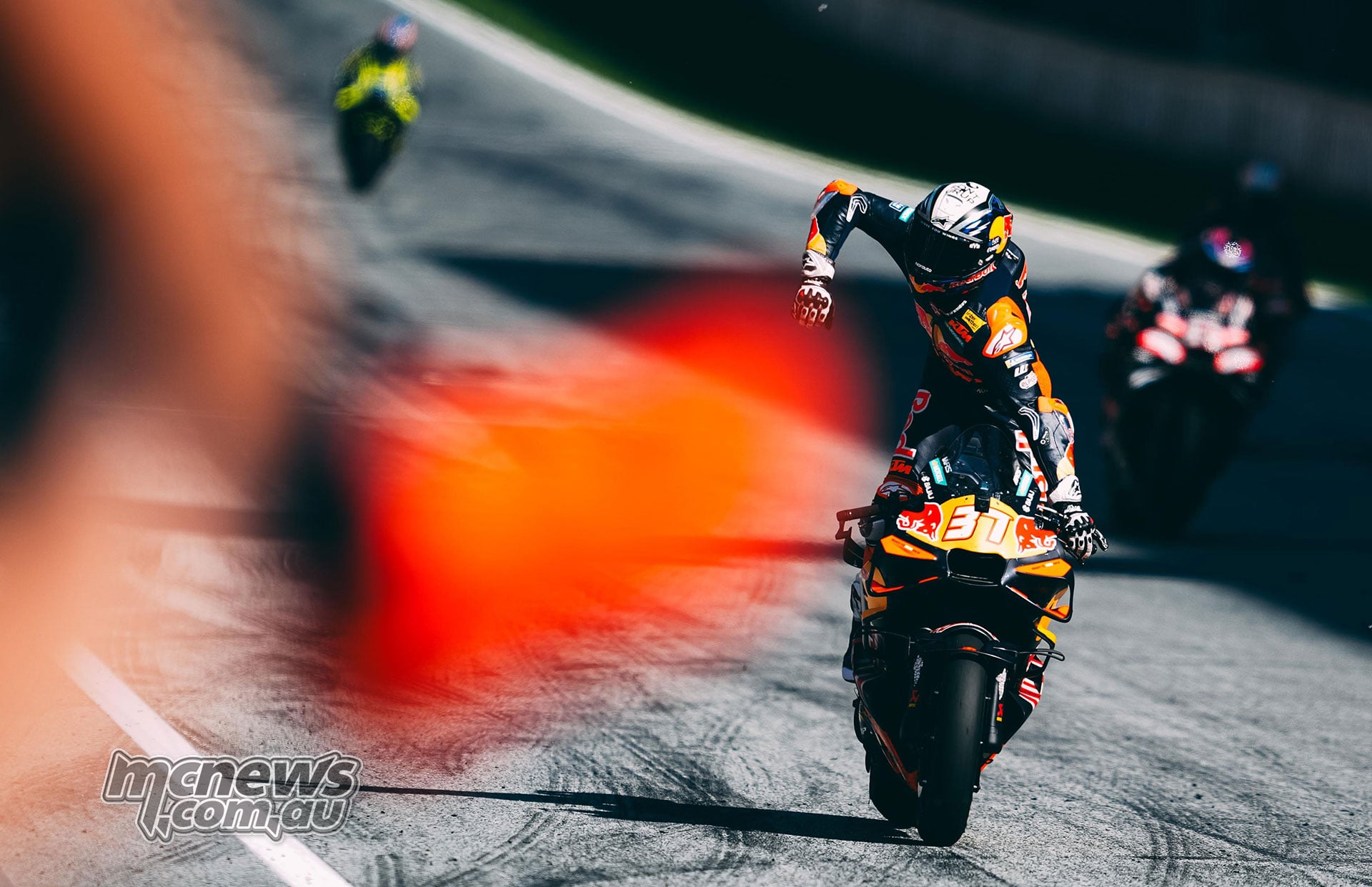 Pedro Acosta raises a fist on his number 37 KTM at the Red Bull Ring finish.
