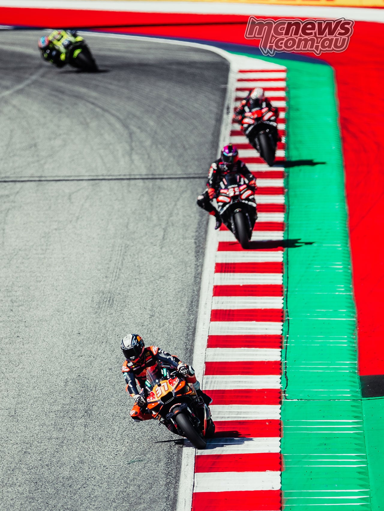 Pedro Acosta leads Jorge Martin, Marco Bezzecchi and Ai Ogura beside the red-and-white kerbing.