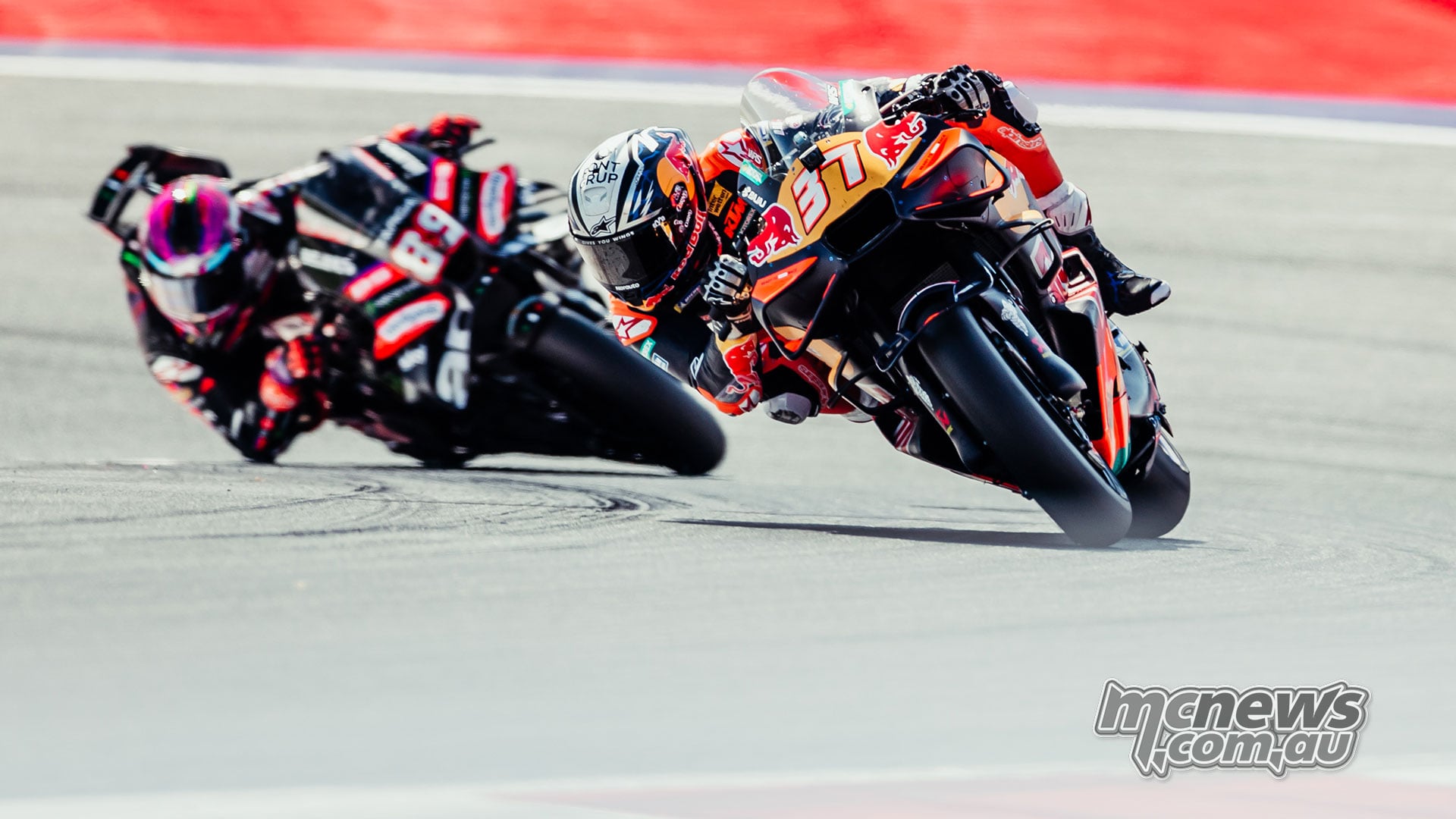 Pedro Acosta leans his KTM into a corner with Jorge Martin following on the Aprilia.