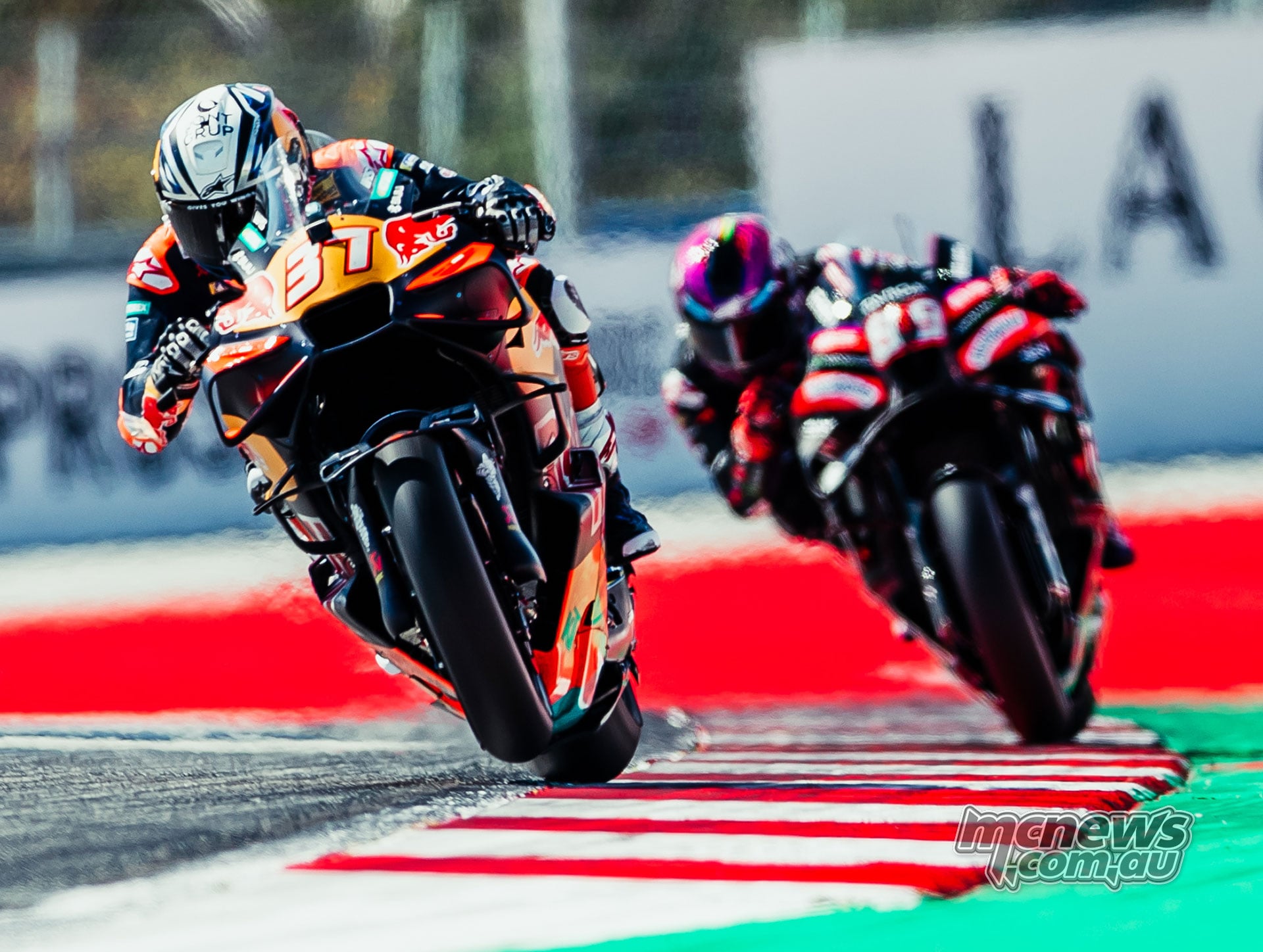 Pedro Acosta accelerates on his KTM with Jorge Martin following on the Aprilia.