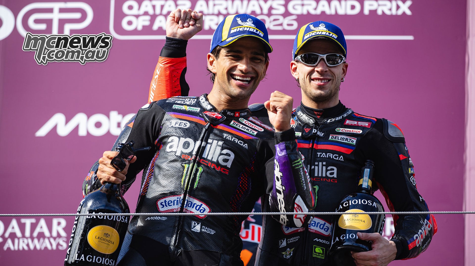 Jorge Martin and Marco Bezzecchi smile with their trophies on the Austrian Grand Prix podium.