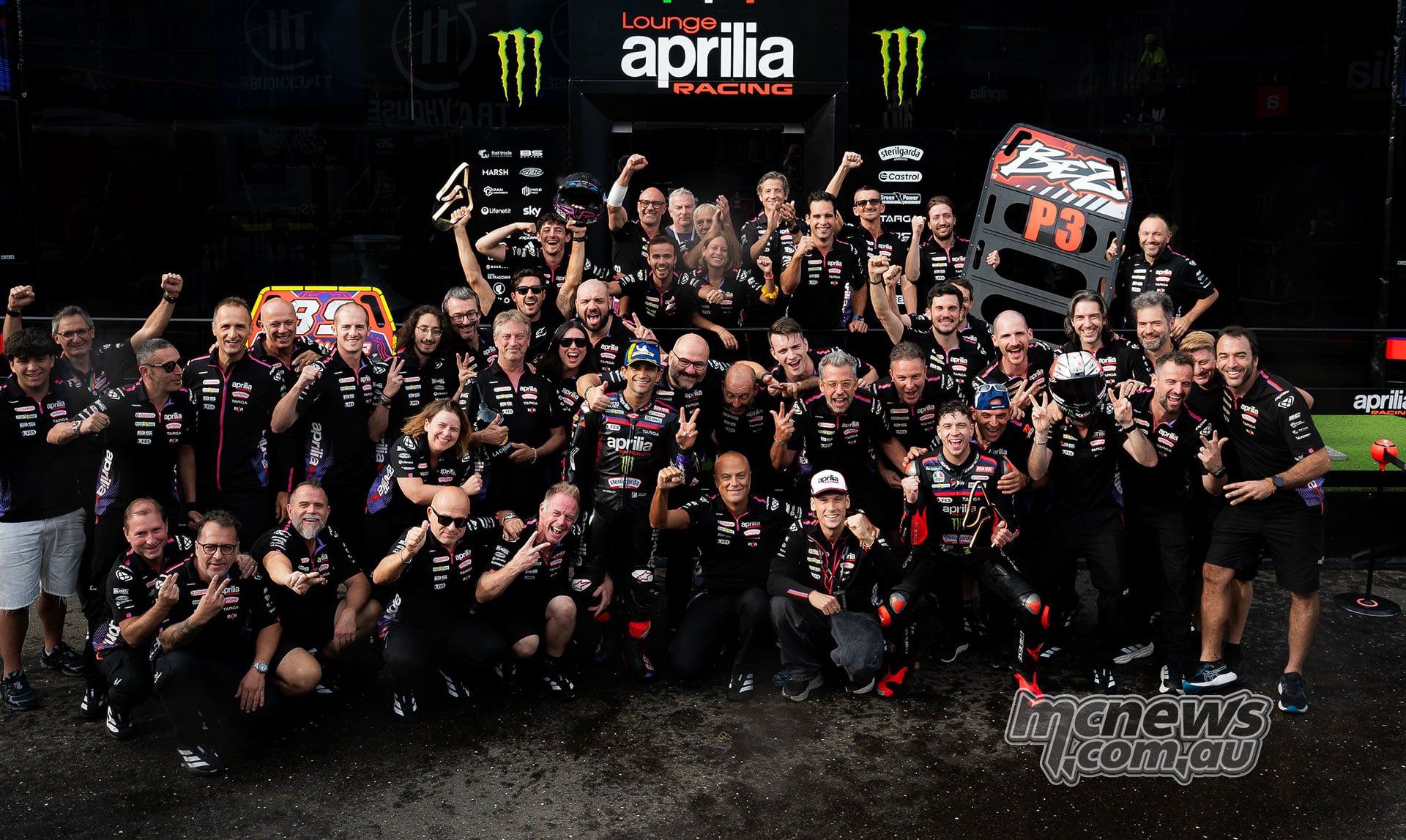 Jorge Martin and Marco Bezzecchi celebrate with the Aprilia team and P2 and P3 pit boards.