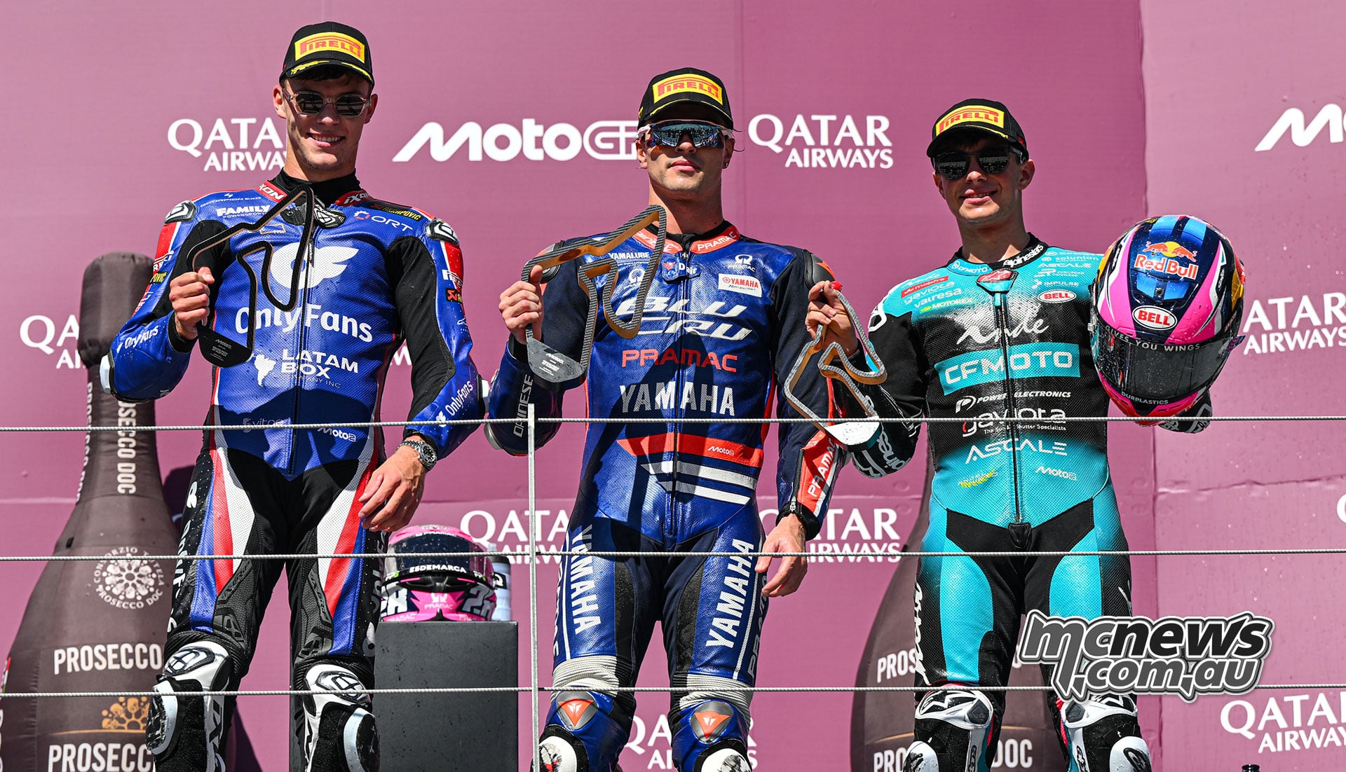 Filip Salac stands to the left of winner Izan Guevara, with David Alonso to the right on the Moto2 podium.