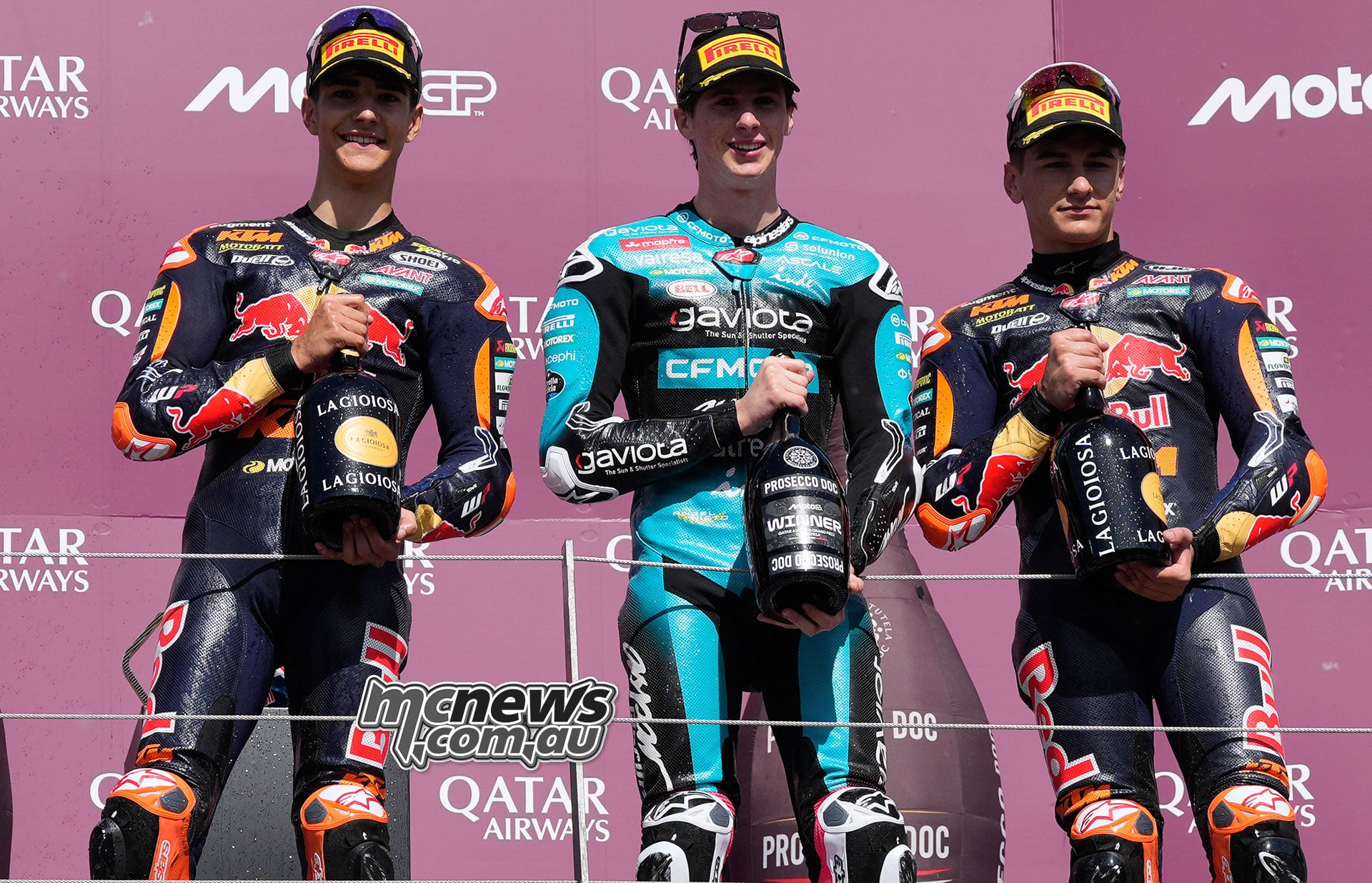 Brian Uriarte, winner Maximo Quiles and Alvaro Carpe stand with their trophies on the Austrian Moto3 podium.