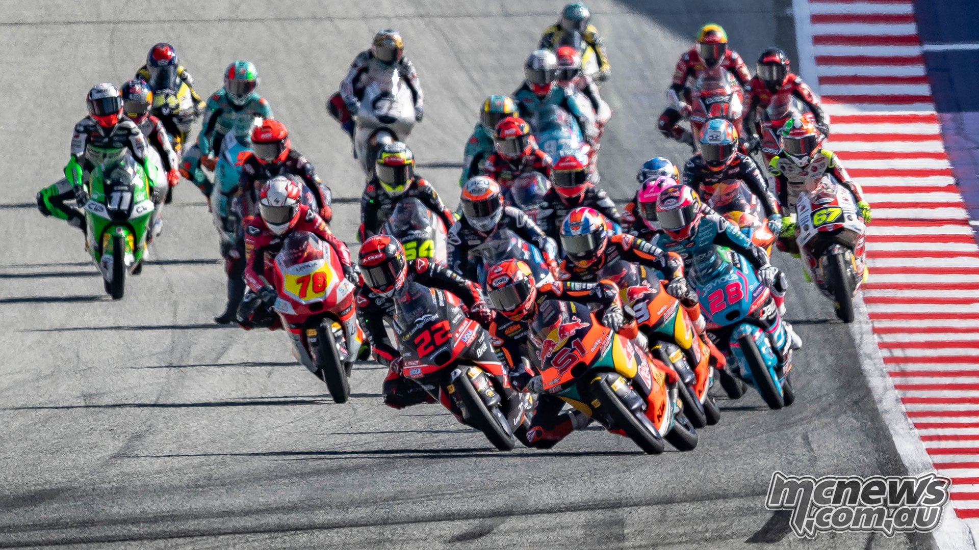 David Almansa, Brian Uriarte and the tightly packed Moto3 field lean through a corner at the Red Bull Ring.